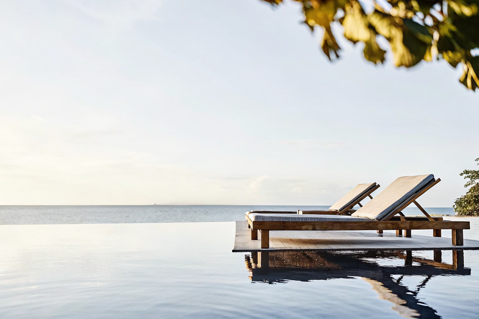 Saltwater infinity pool overlooking the Sulu Sea at sunset