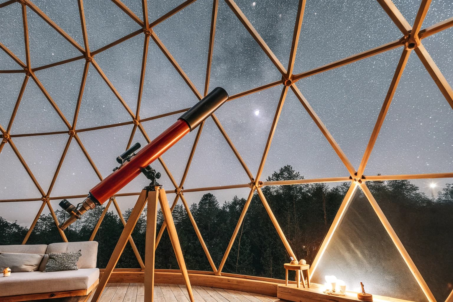 Observation deck with telescope overlooking starry night sky